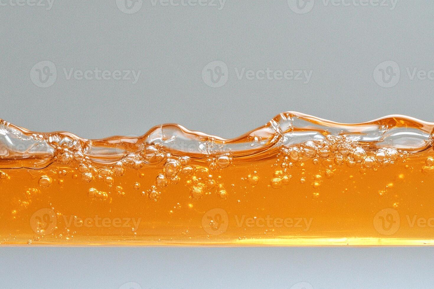 A glass of orange juice with bubbles photo