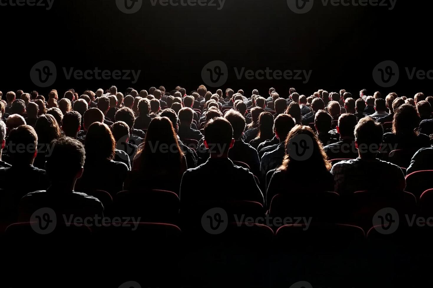 Audience in auditorium with light source photo