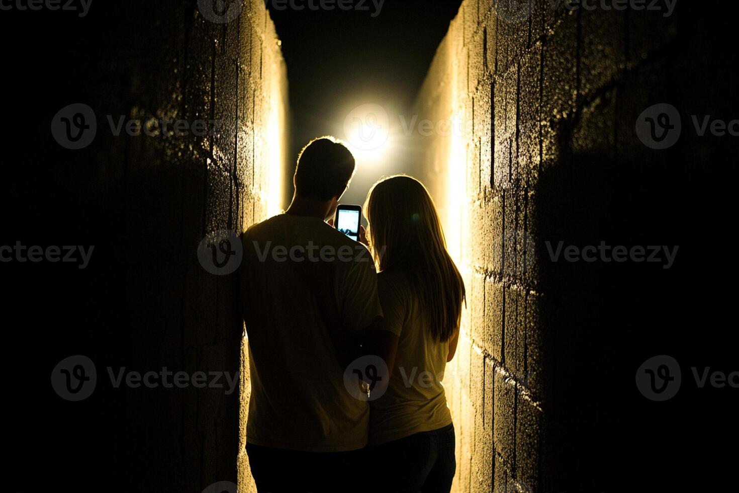 A couple standing in a dark tunnel photo