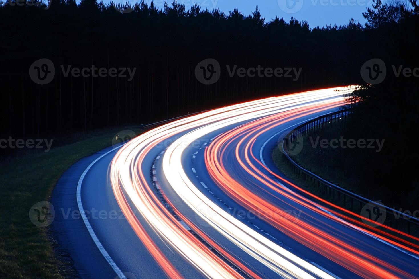 A long exposure of a highway with light trails photo