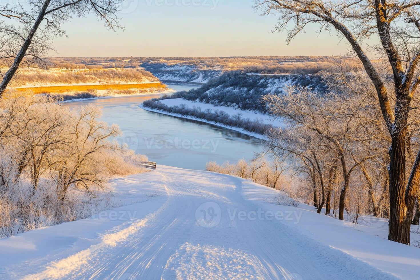 A snowy landscape with trees and a river photo