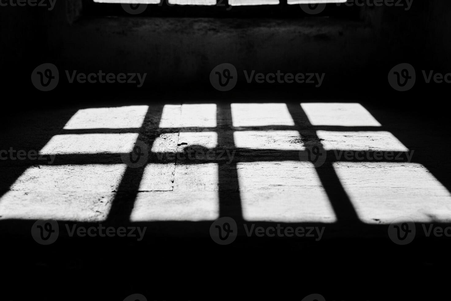 A black and white photo of a window with light coming through