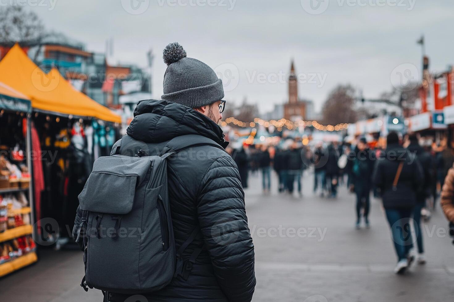A man with a backpack standing in front of a market photo