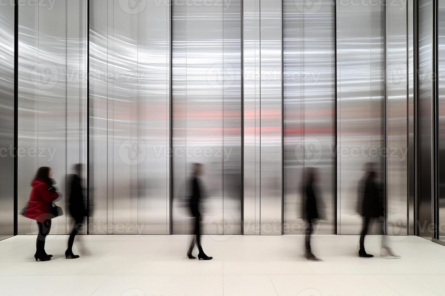 People walking in an empty room with glass walls photo