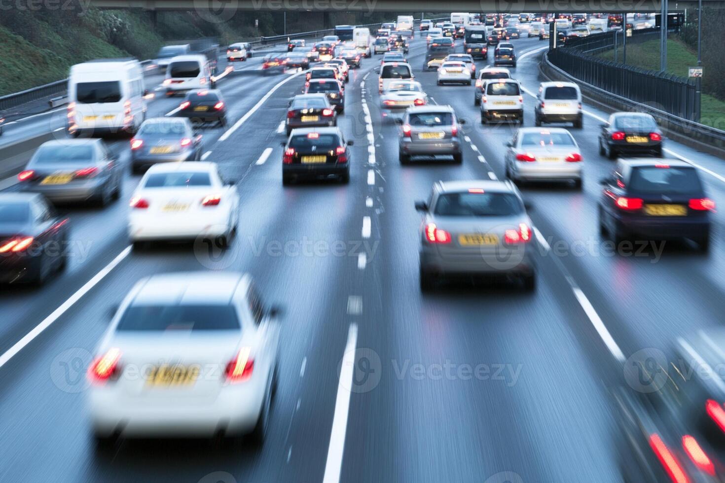 Many cars are driving on a busy highway photo