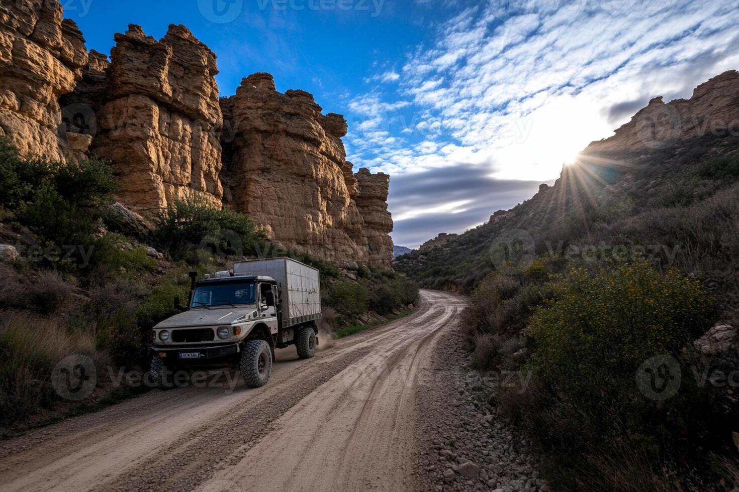 A truck driving down a dirt road photo