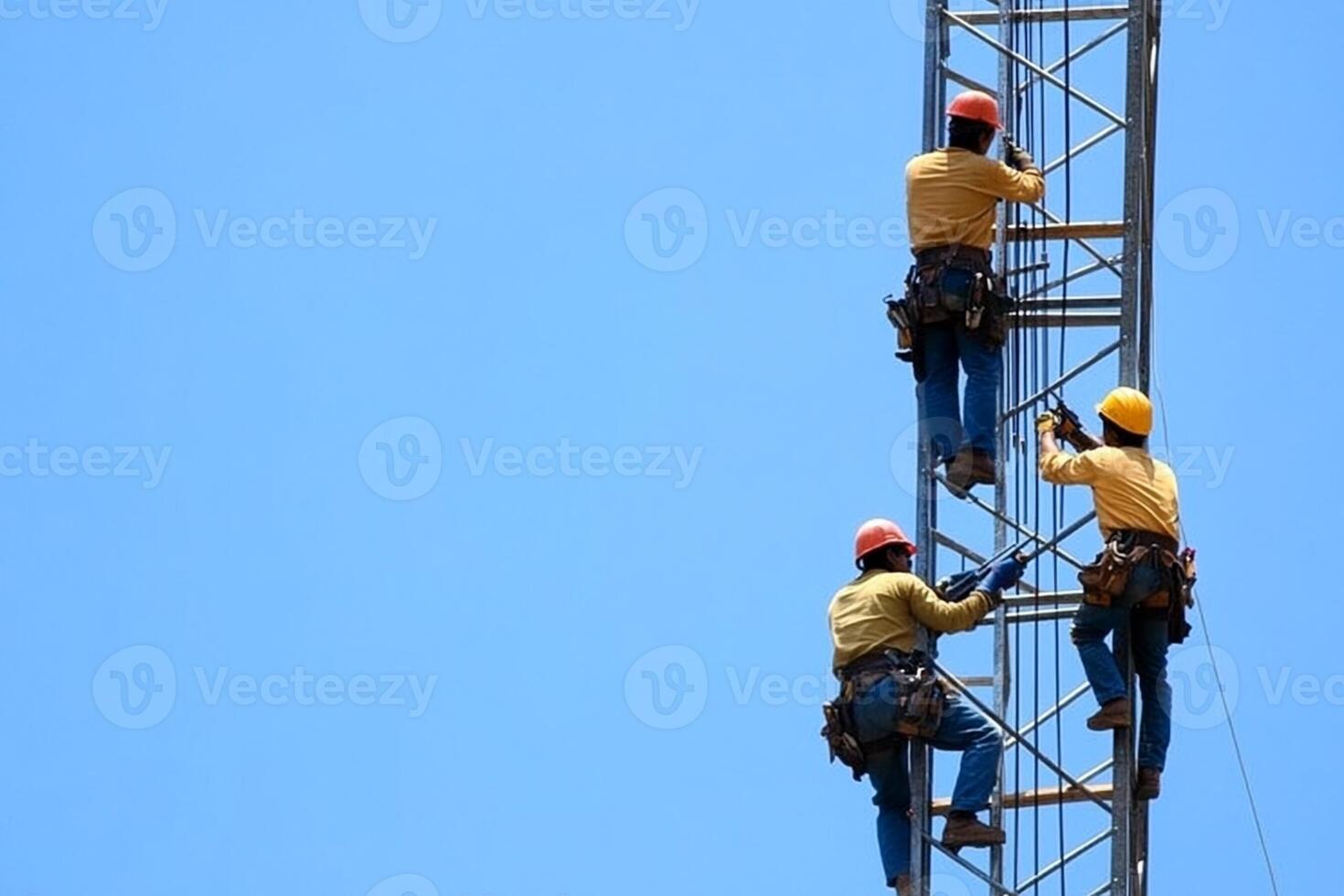 Three men on a tower working on a construction site photo