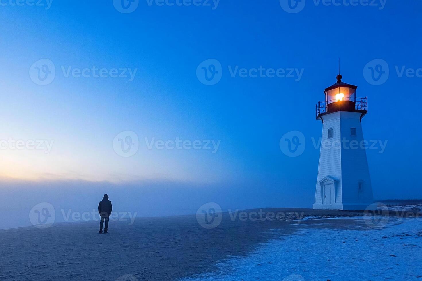 A person standing in front of a lighthouse at sunrise photo