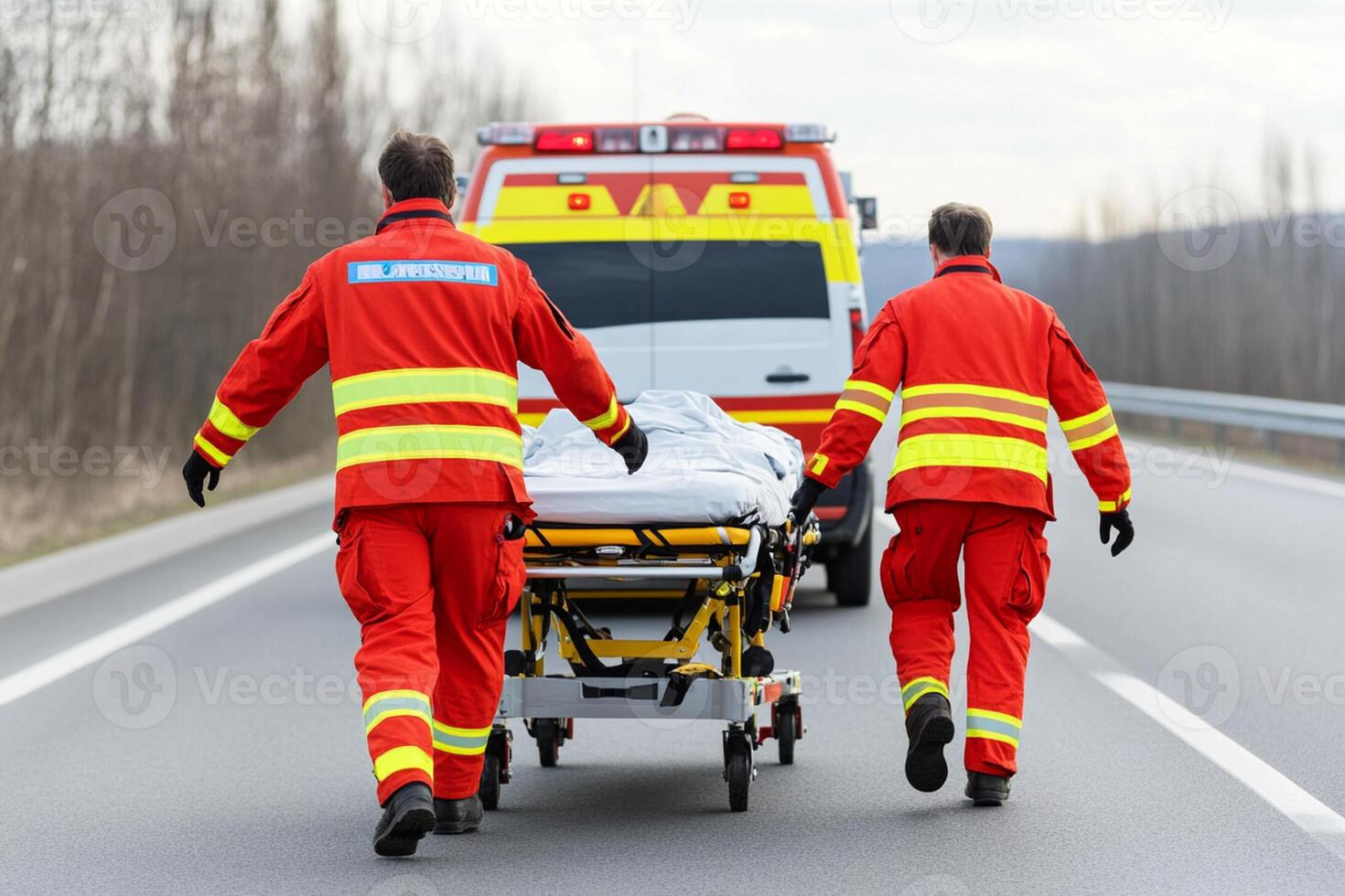 Two men in red uniforms carrying a patient on a stretcher photo