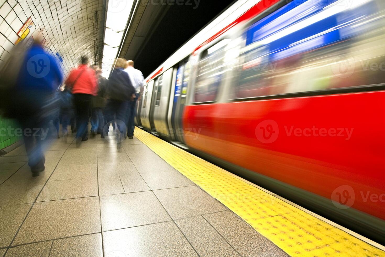 A subway train is moving through a station photo