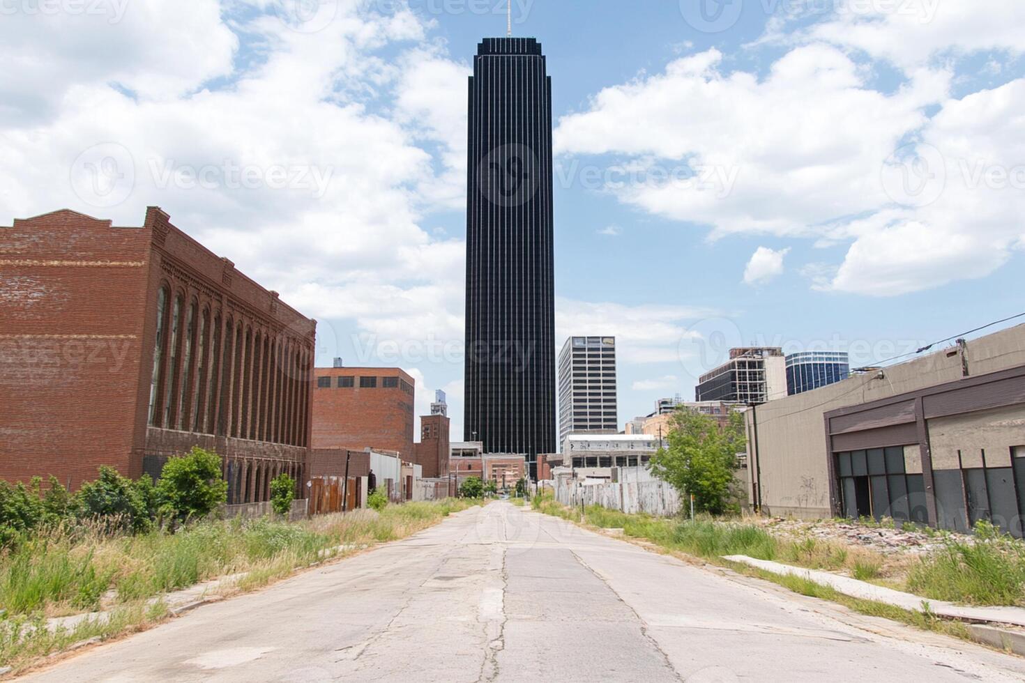 A paved road with a tall building in the background photo