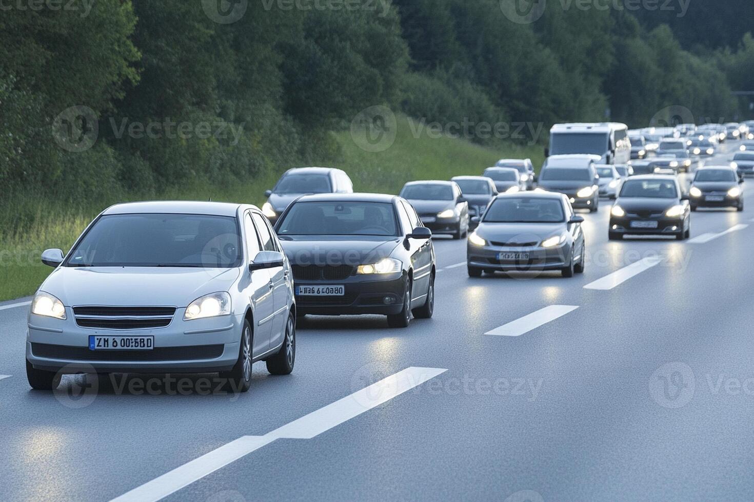 Cars driving on a highway with trees and bushes in the background photo