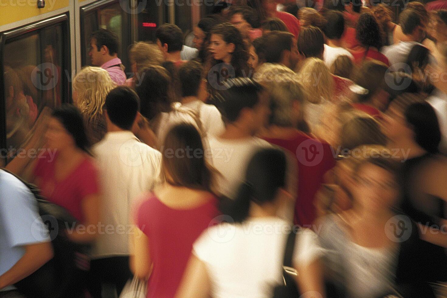 A crowd of people standing in a train station photo