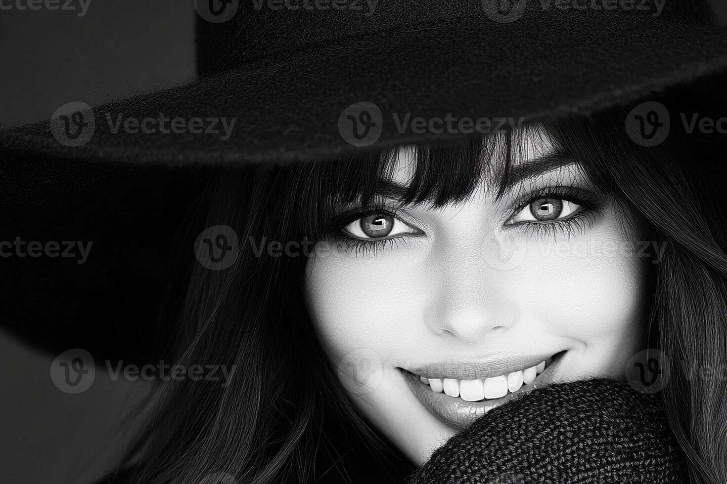 A black and white photo of a woman wearing a hat