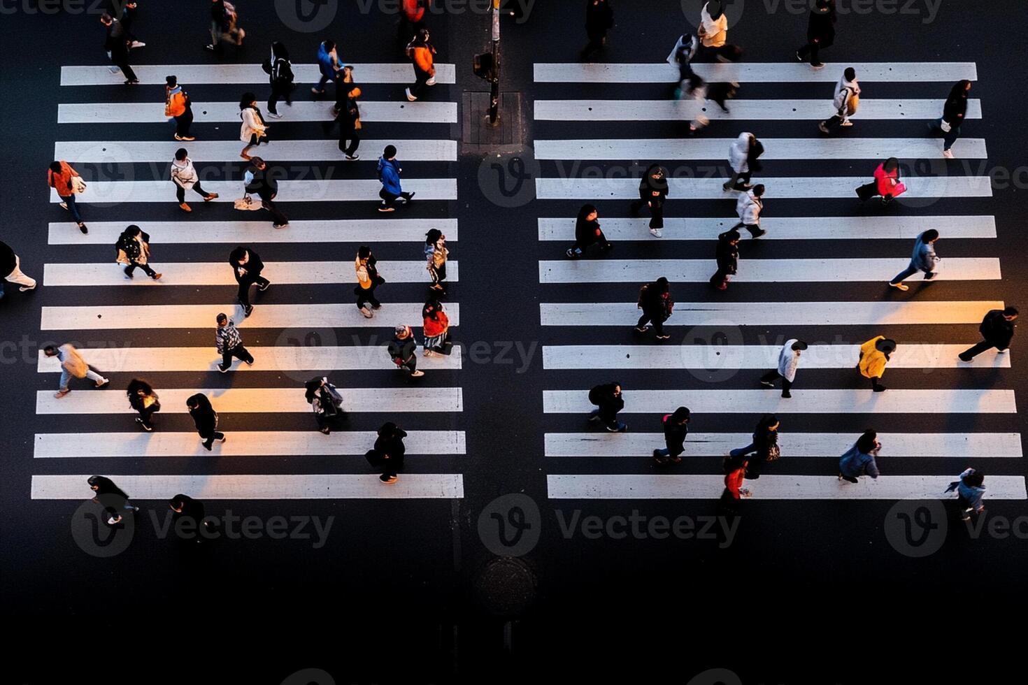 A group of people crossing a street in a city photo