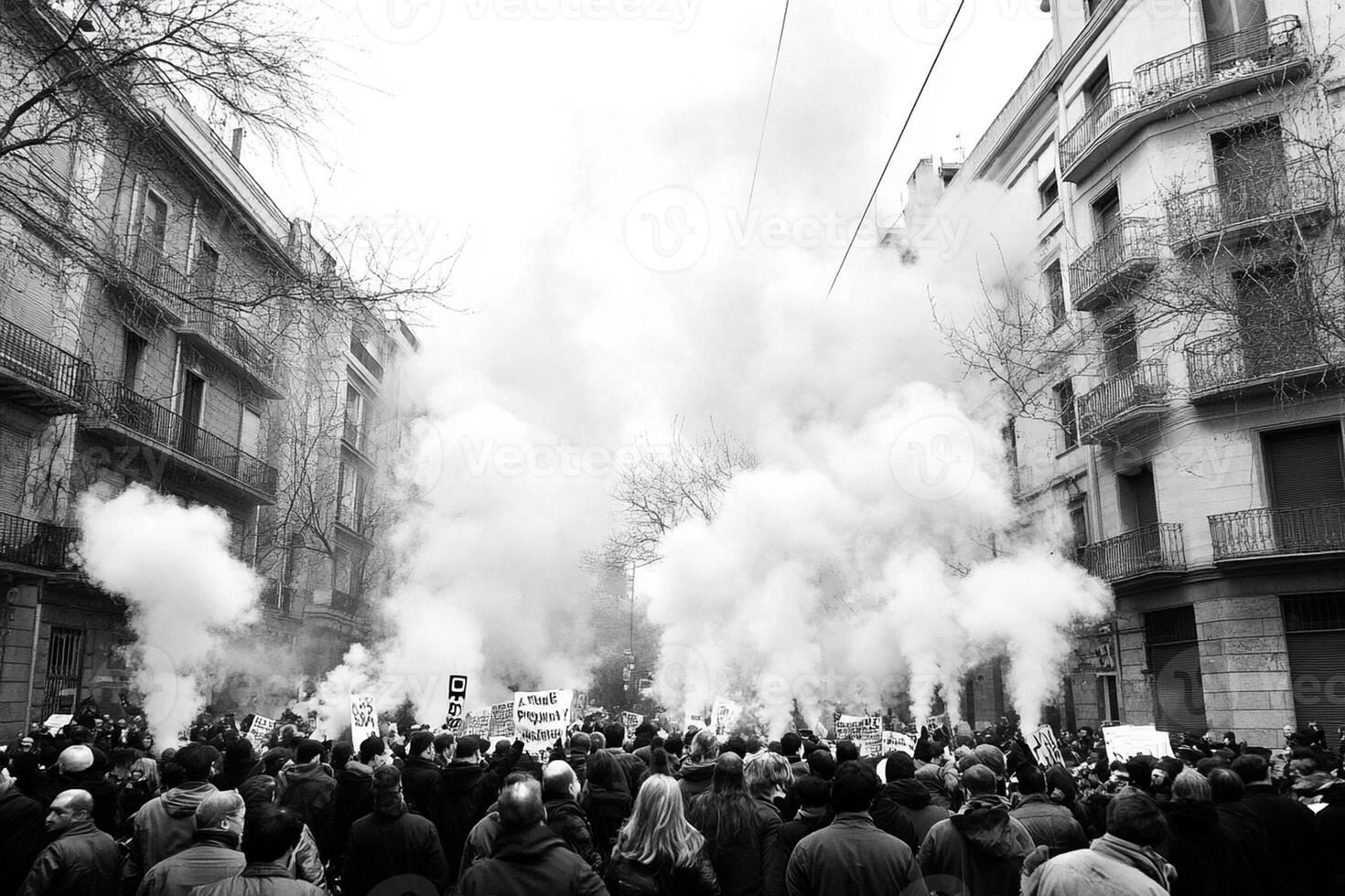 A crowd of people are standing in the street with smoke coming out of the buildings photo