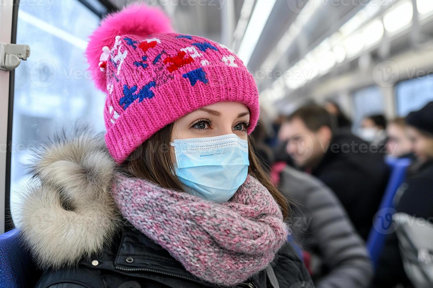 A woman wearing a face mask on a train photo