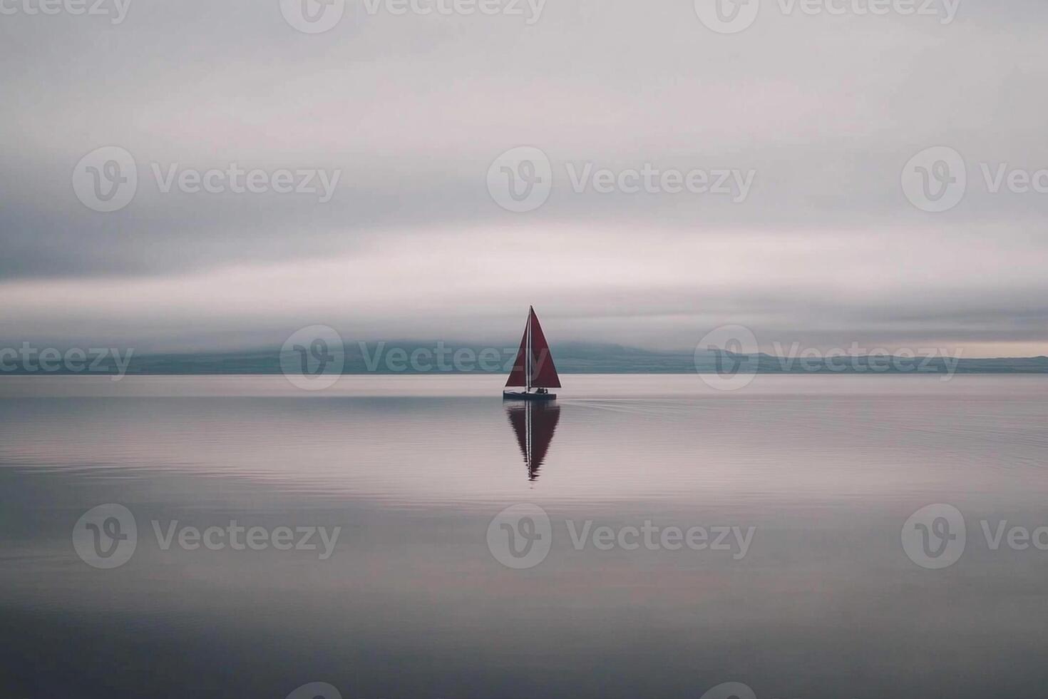 A sailboat floating in the water on a cloudy day photo
