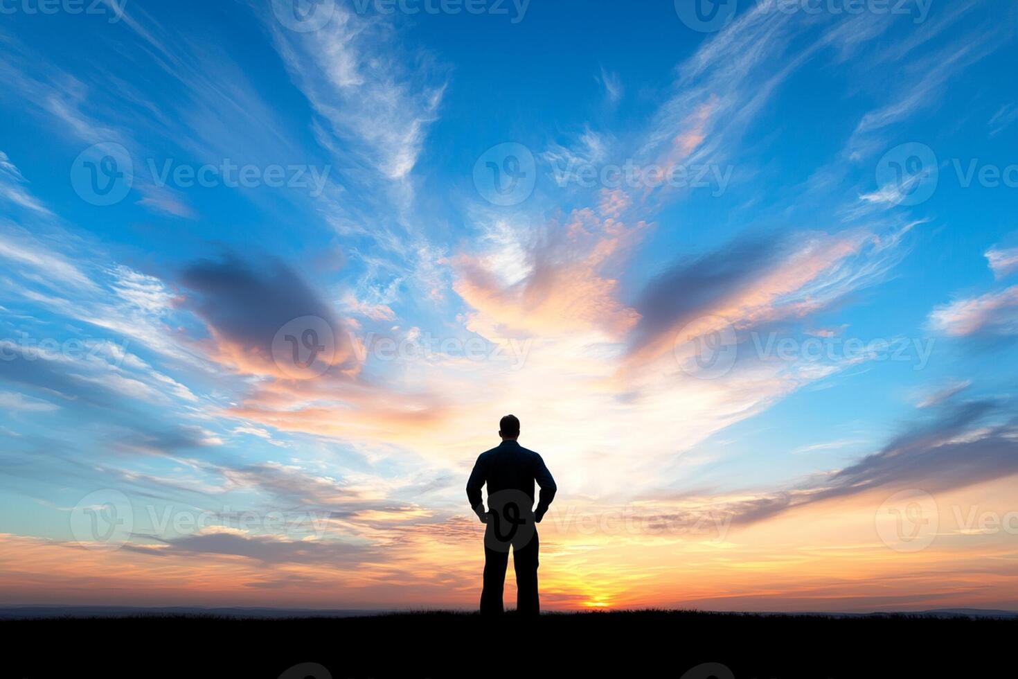 A man standing on a hill with a sky background photo