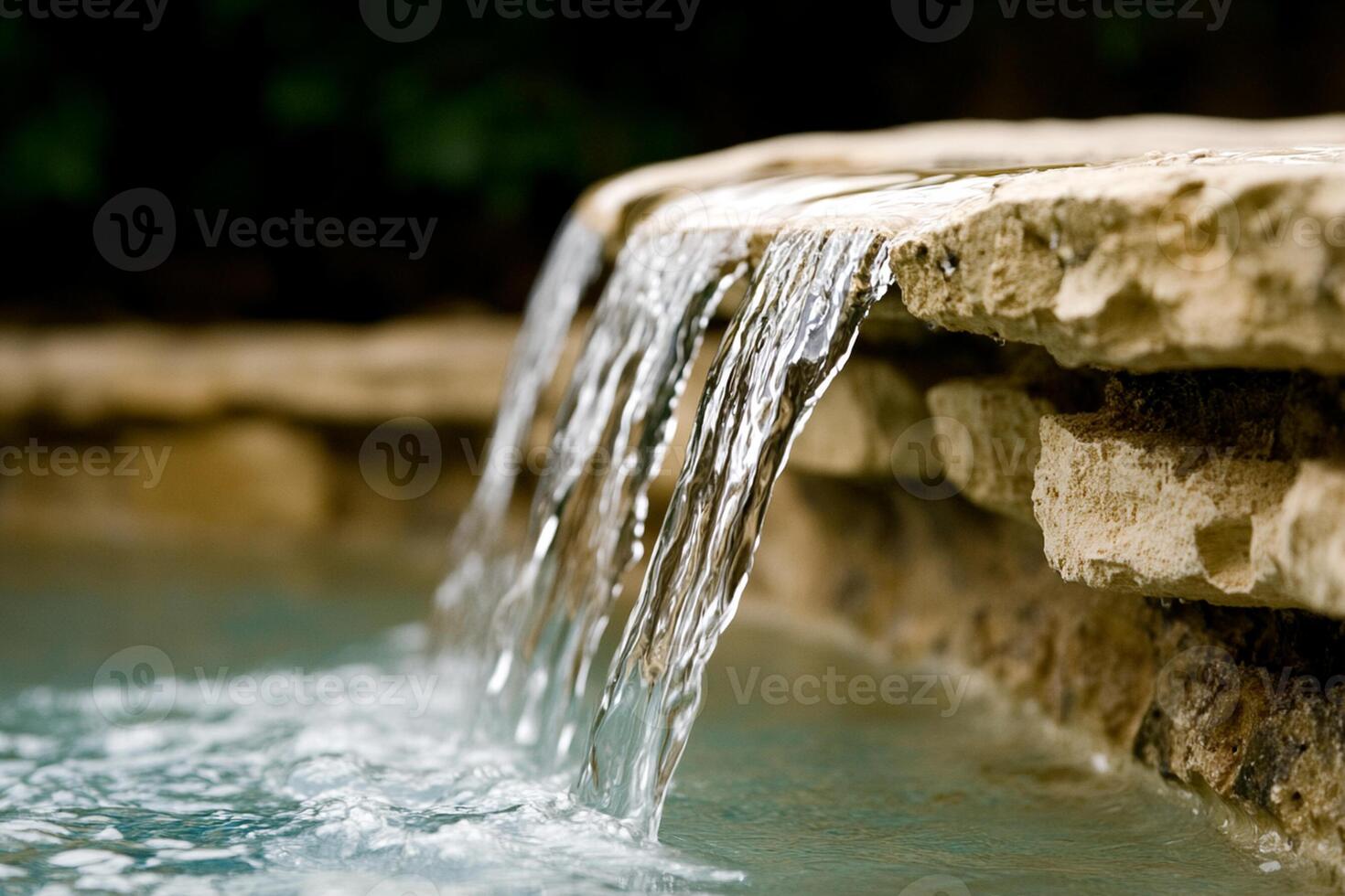A waterfall flowing over a stone ledge photo