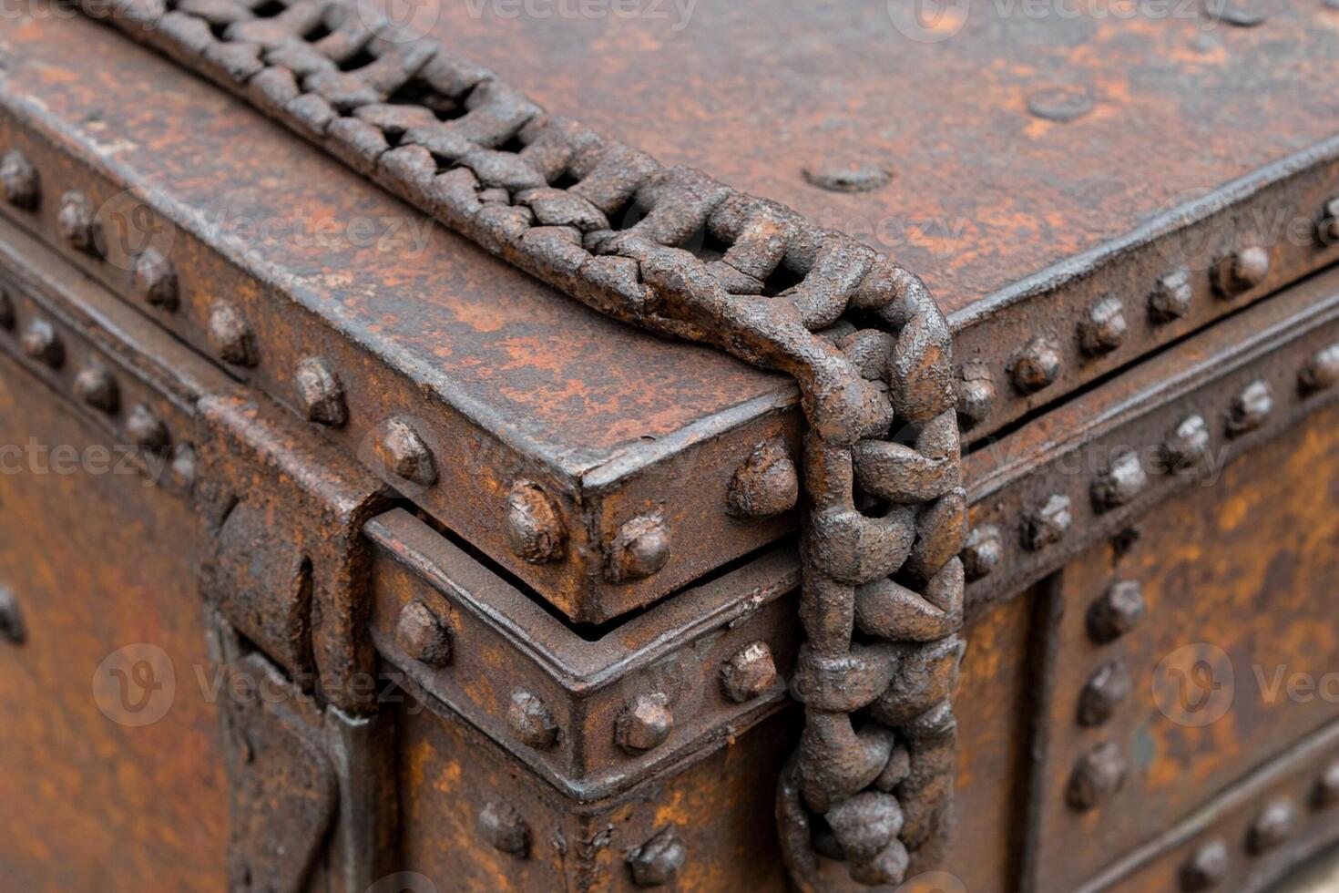 A rusty metal box with rivets and chains photo