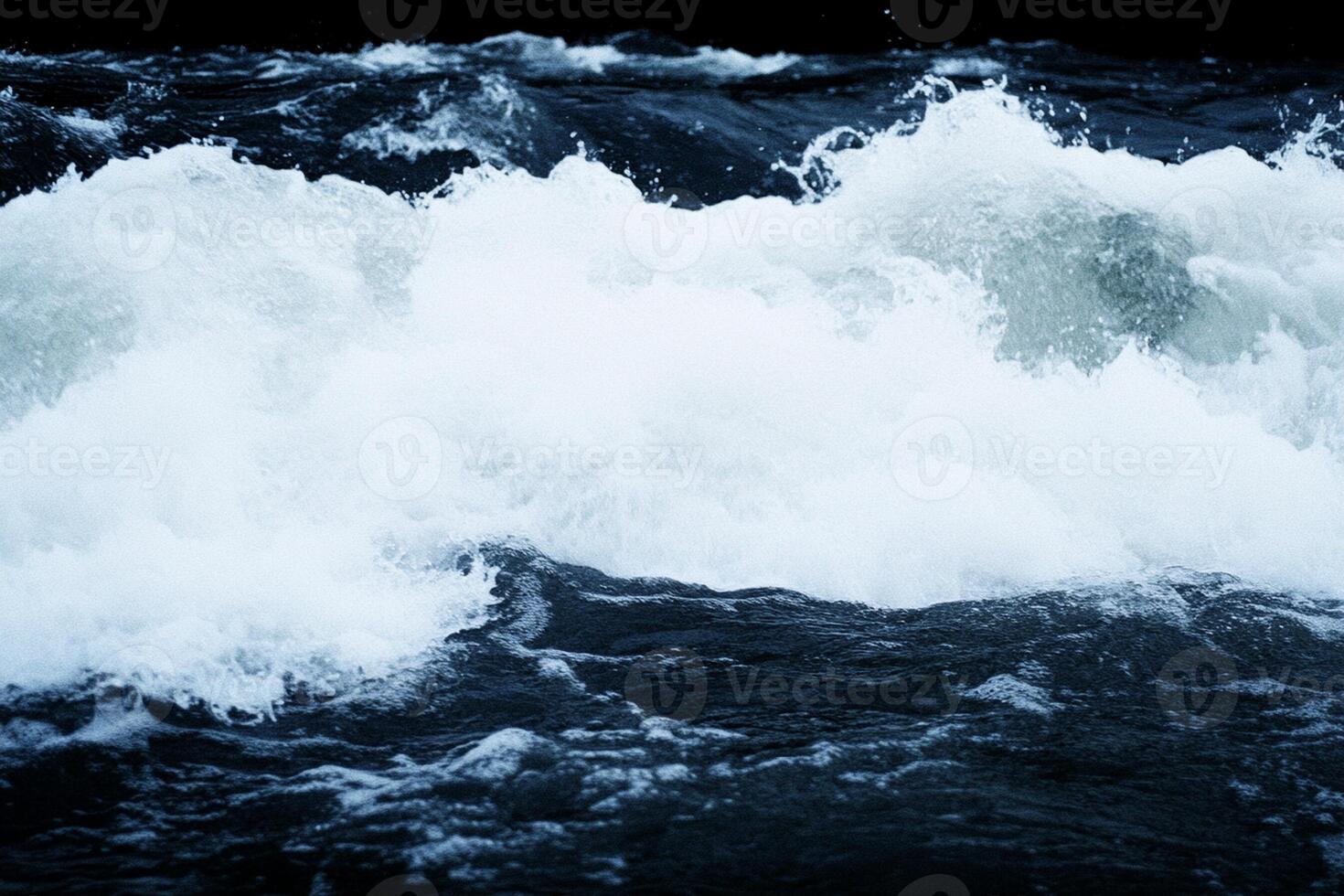 A person surfing on a wave in the ocean photo