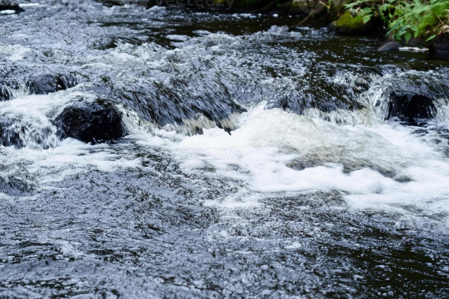 A river with water flowing over rocks photo
