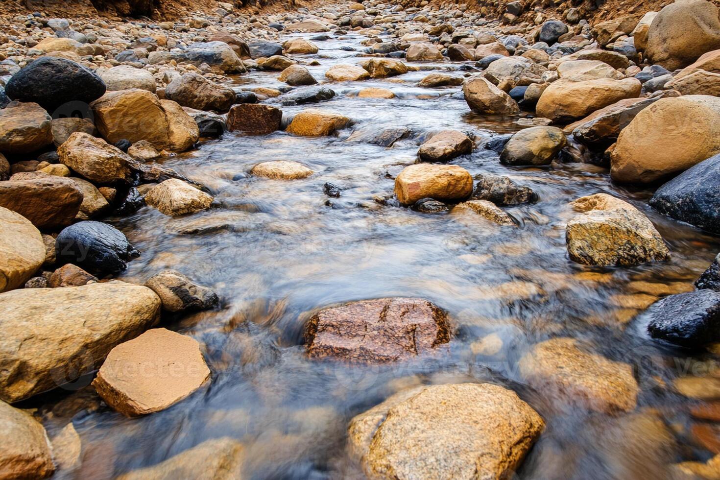 A stream of water flows through a rocky area photo
