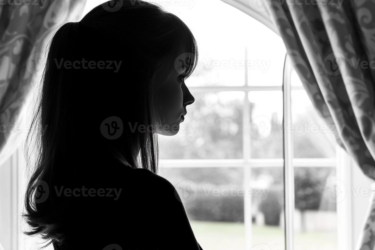 A woman is standing in front of a window photo
