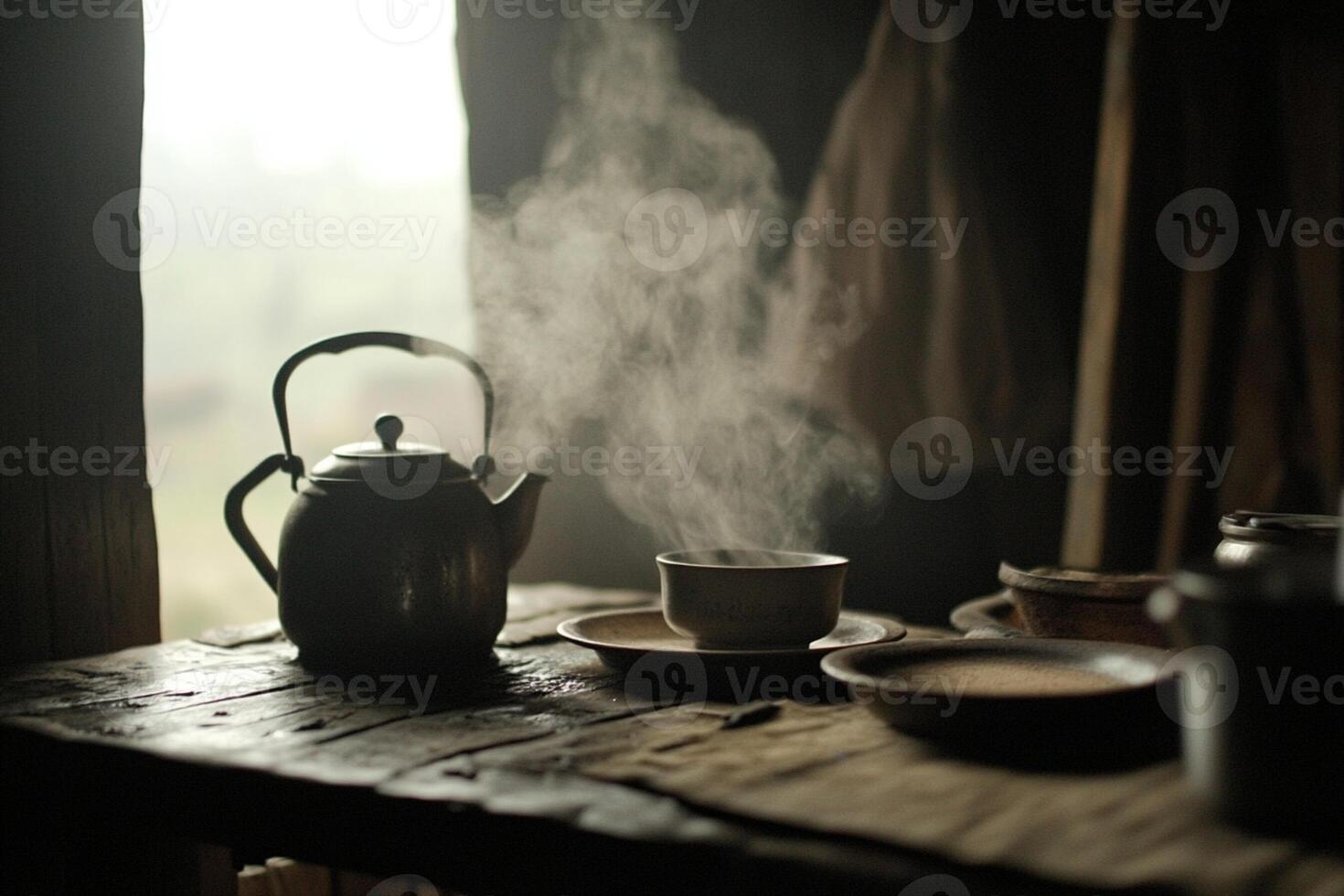 A table with a kettle and cups on it photo