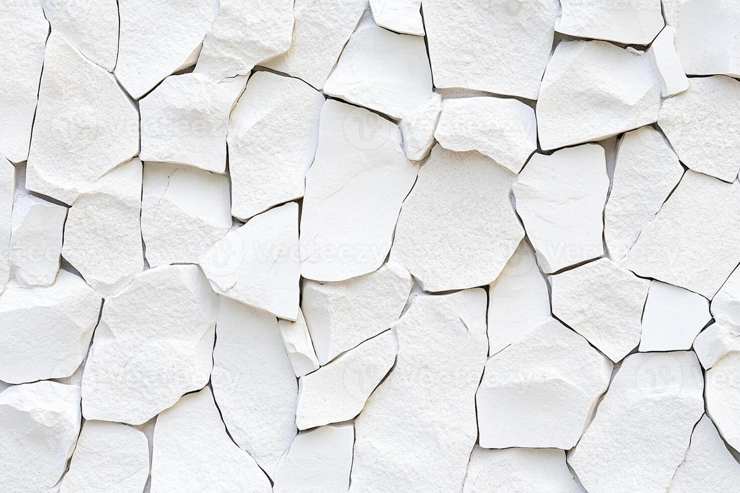 A wall made of white stone with many different shapes photo