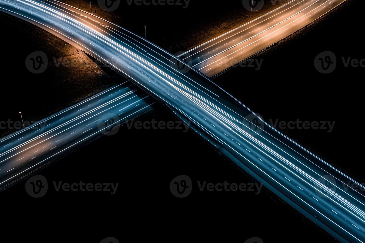 An aerial view of two highway overpasses at night photo