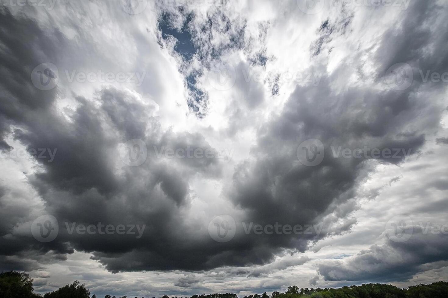 A large cloud is seen in the sky above a field photo
