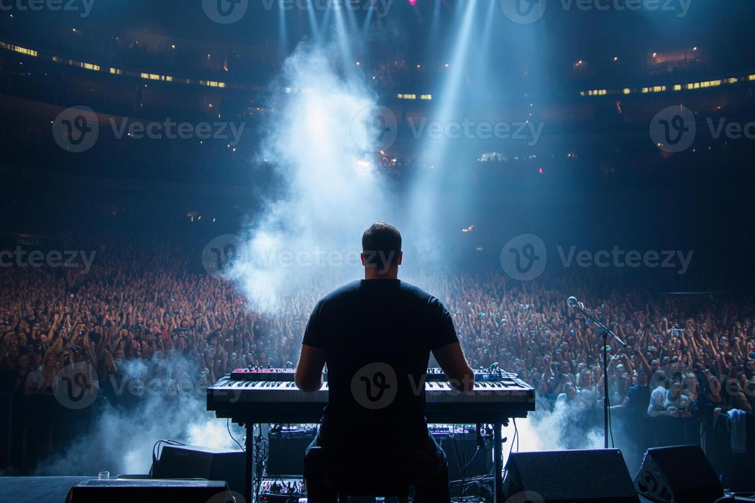 A man playing an electronic keyboard in front of a crowd photo