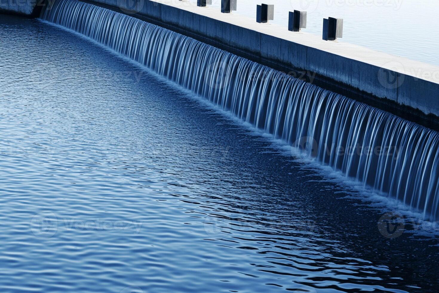 A large water flow coming out of a dam photo