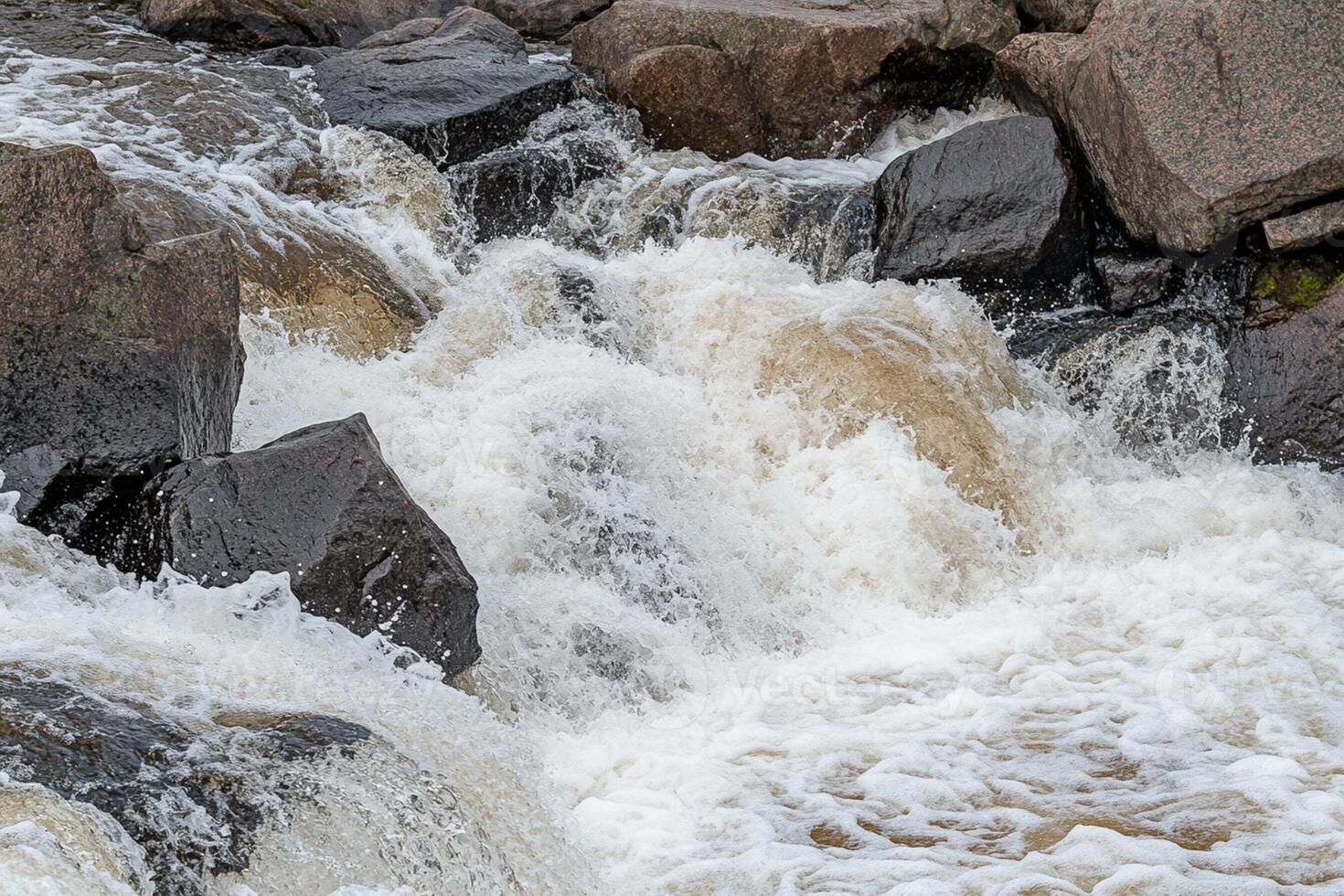A man riding a surf board in a river photo