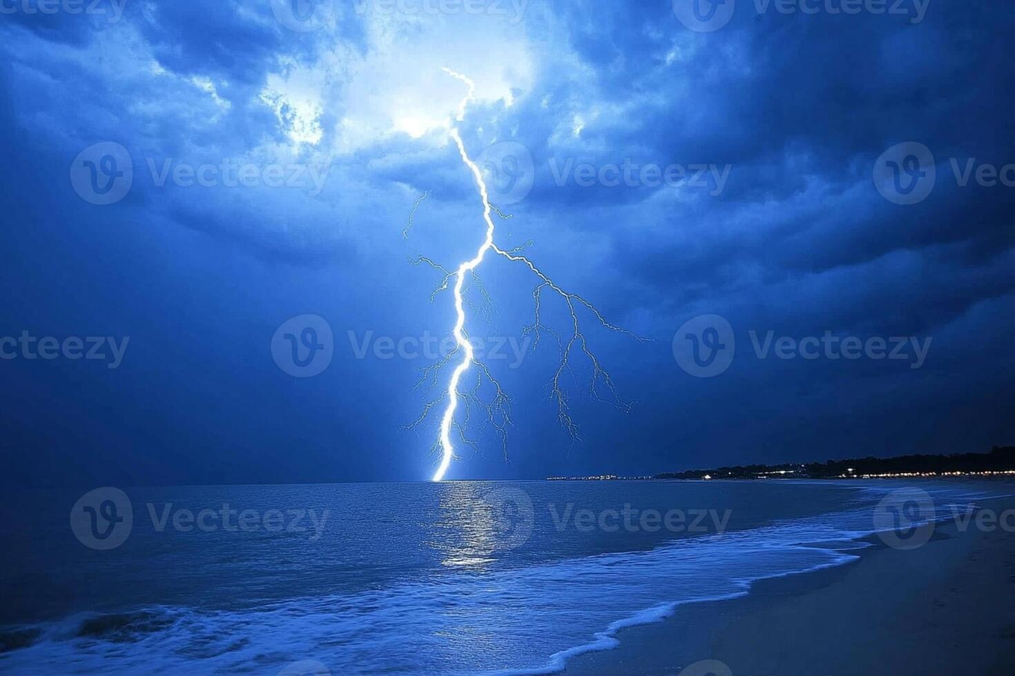 A lightning bolt strikes the ocean during a storm photo
