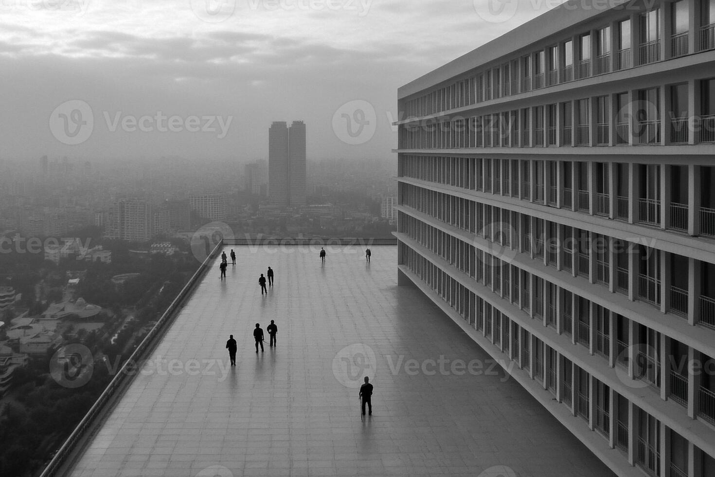 People walking on a rooftop overlooking a city photo