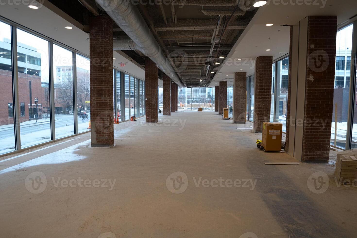 A long hallway with a lot of windows and a lot of concrete photo