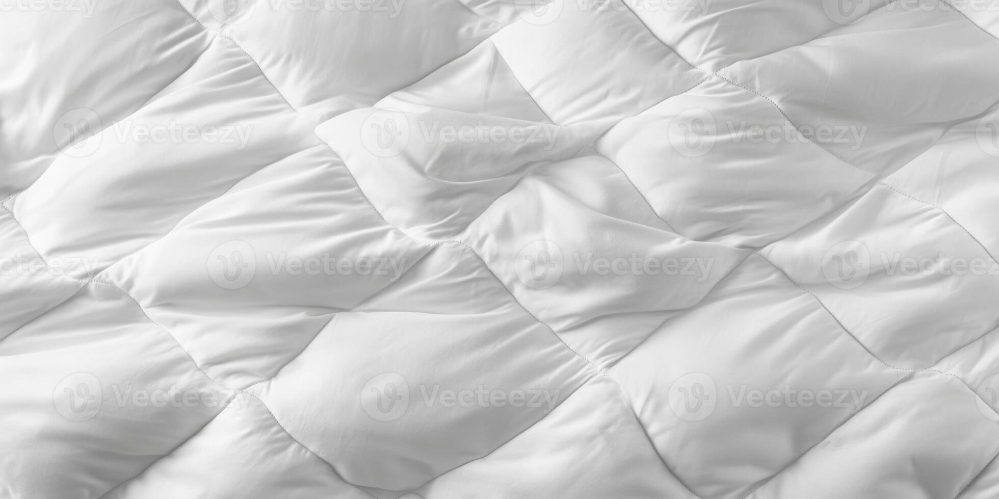 Luxury white bedding spread across a neatly made bed in a cozy interior setting during daylight hours photo