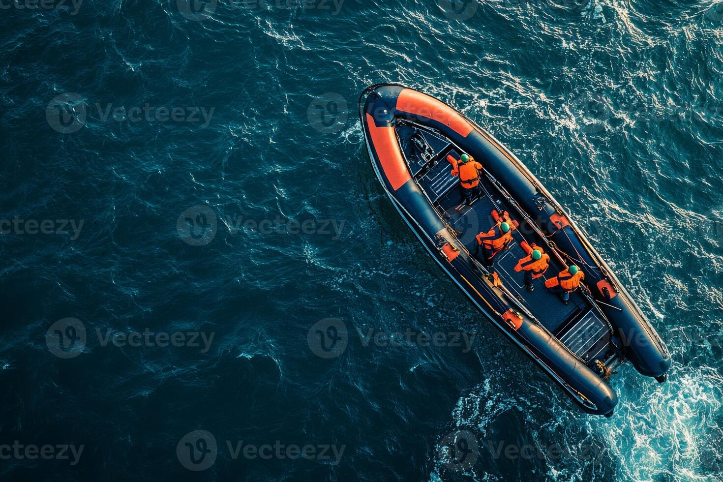 Aerial view of a maintenance boat with workers in life jackets near an offshore wind turbine platform photo