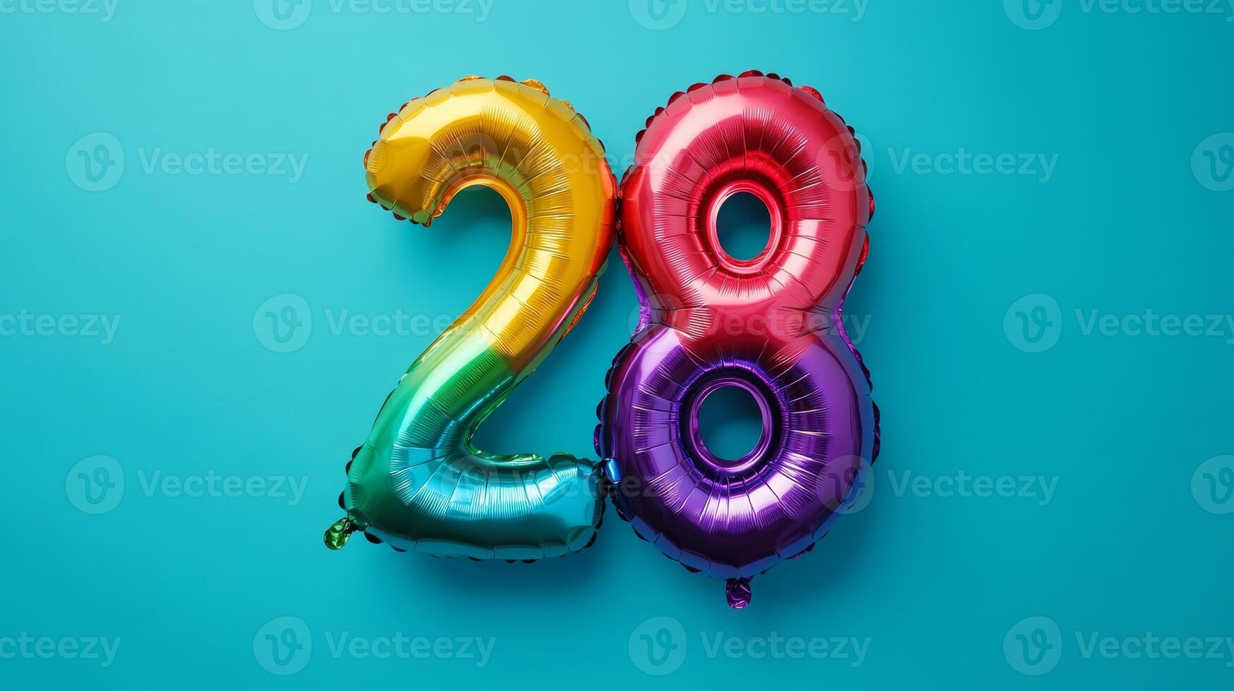 Colorful rainbow foil balloon depicting the number twenty-eight set against a bright blue background for celebrations and events photo