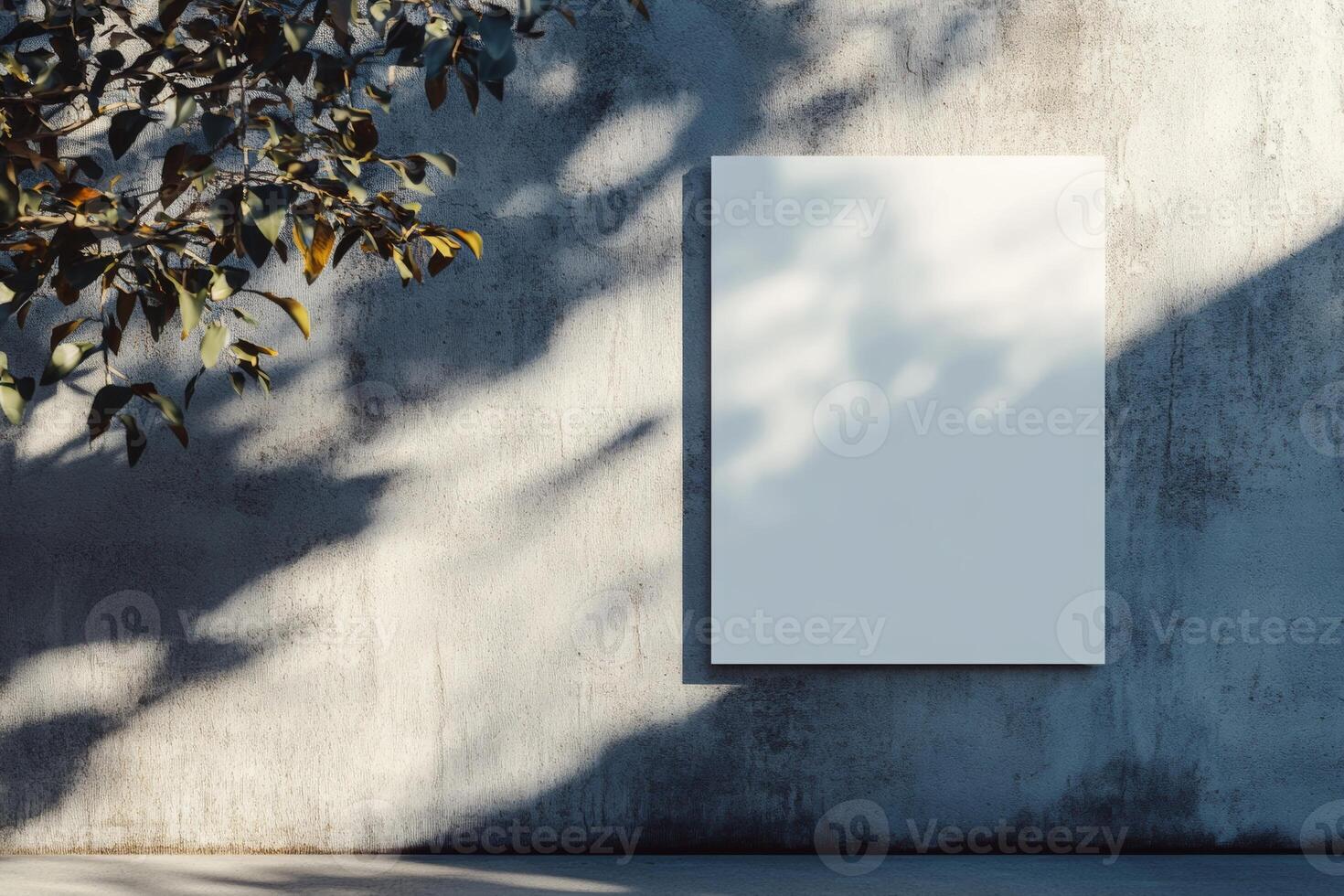 Empty poster on a concrete wall illuminated by sunlight, creating soft shadows and a minimalist backdrop for artistic expression photo