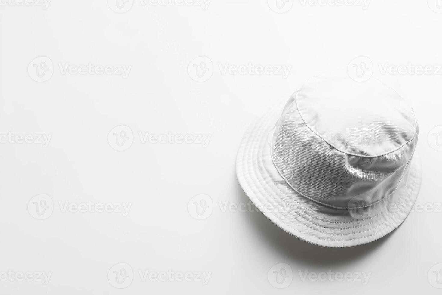 A stylish white bucket hat resting on a smooth white background, perfect for sunny days and casual outings photo