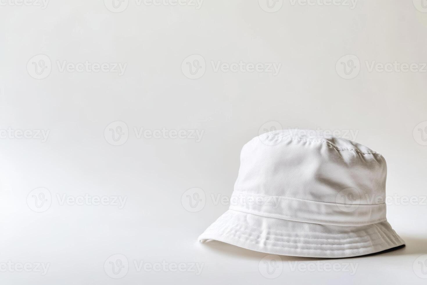 A plain white bucket hat placed on a clean white background, ideal for showcasing personalized designs or branding opportunities photo