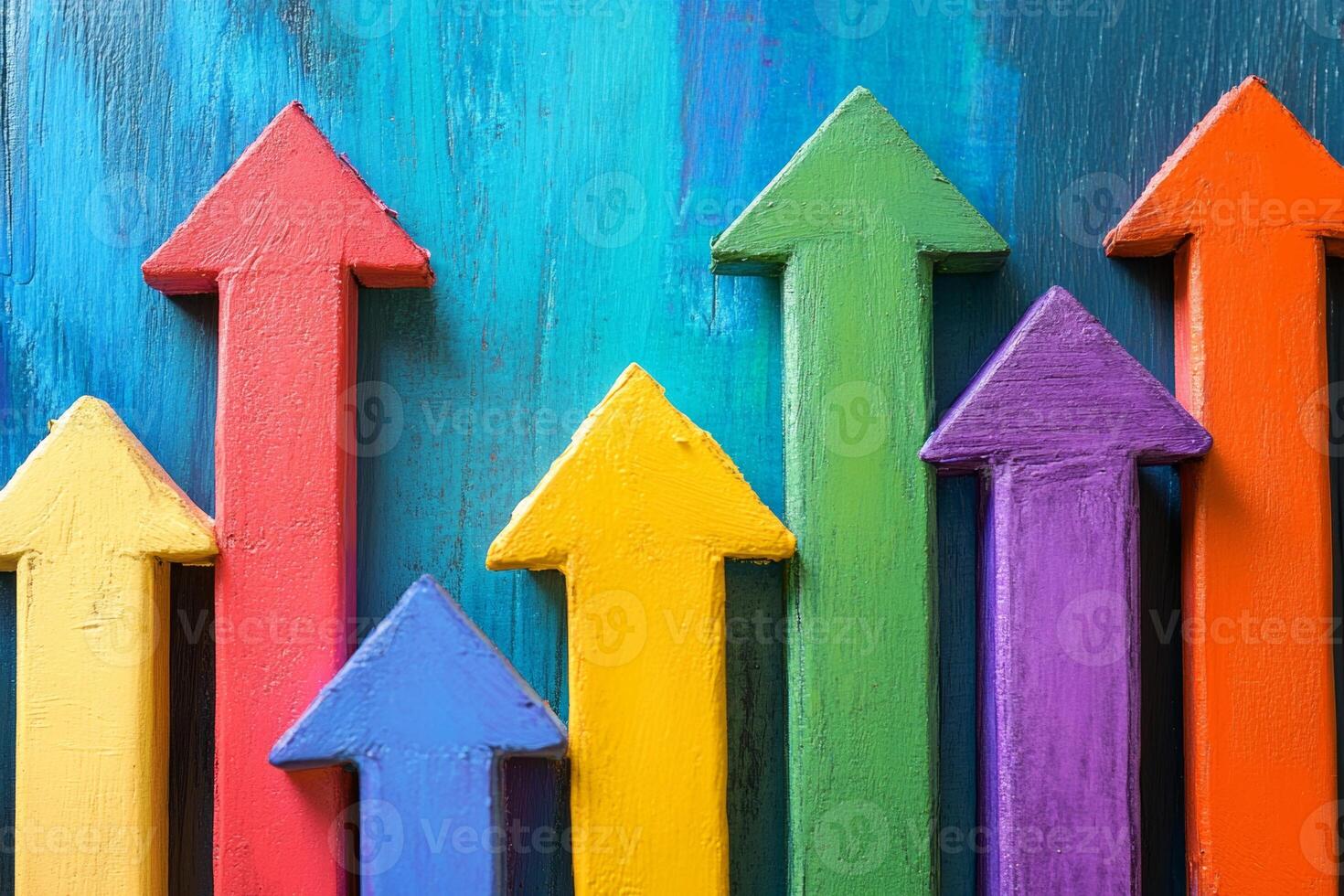 Colorful upward arrows representing progress and growth against a vibrant background during daylight photo