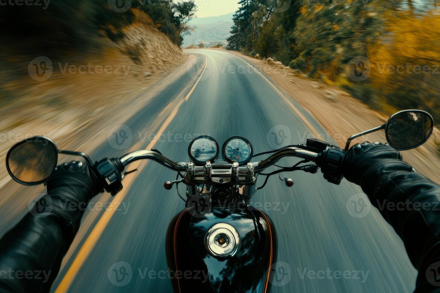 A biker enjoys the freedom of the open road while cruising down a scenic highway during a clear day photo