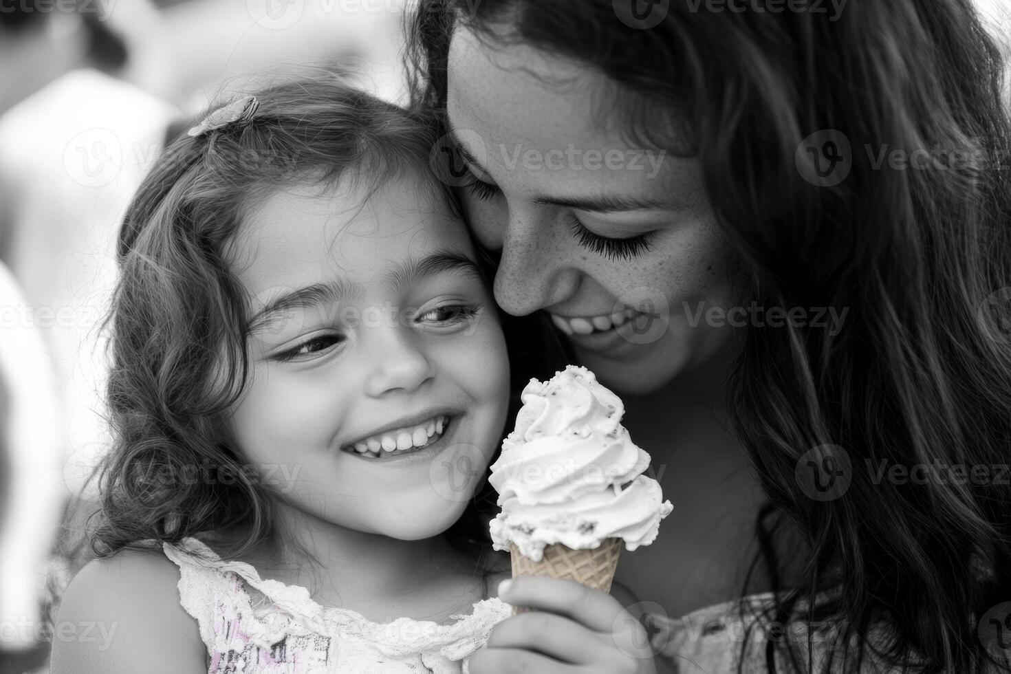 Mother and daughter share joyful ice cream moment outdoors during a sunny day in the park, creating sweet memories together photo