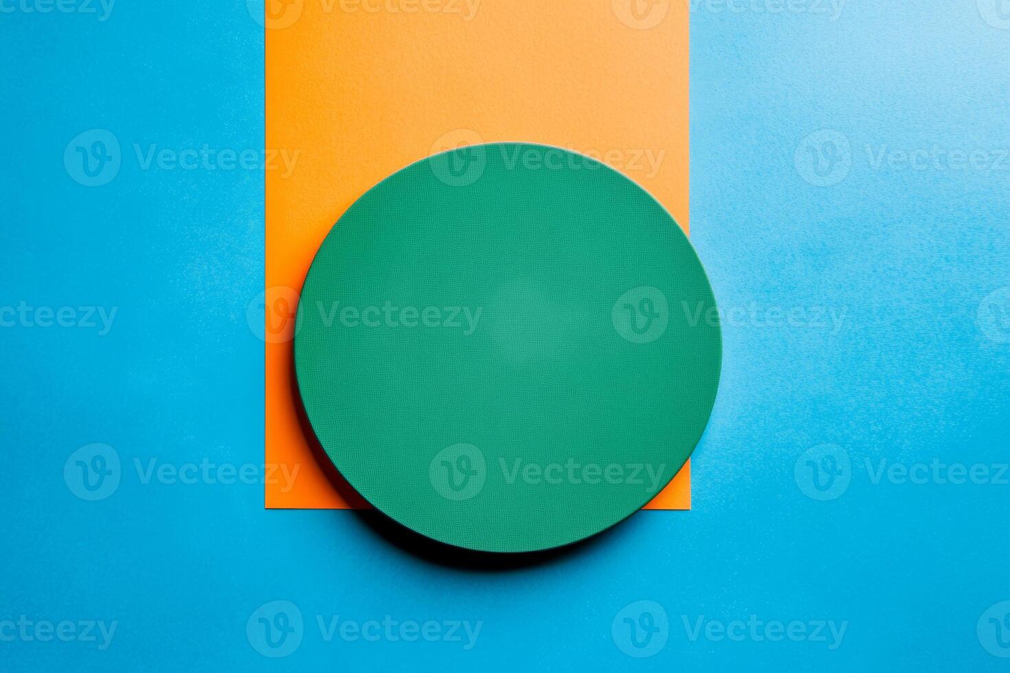 Minimalist green circle centered on vibrant blue and orange split background creating a modern art feel photo