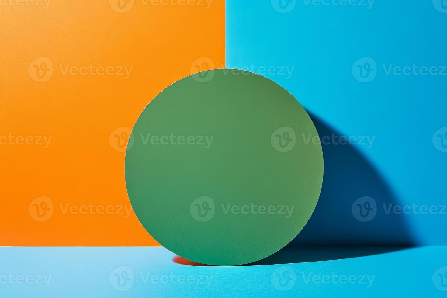 Minimalist composition featuring a green circle on a vibrant blue and orange split background photo